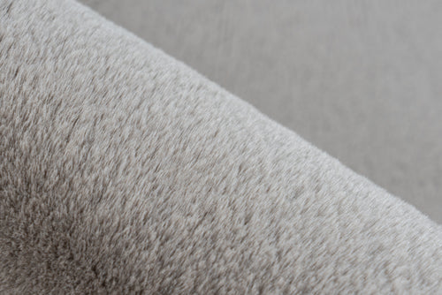 Ingezoomd op de fijne vezels van het taupe Could vloerkleed voor een comfortabele uitstraling