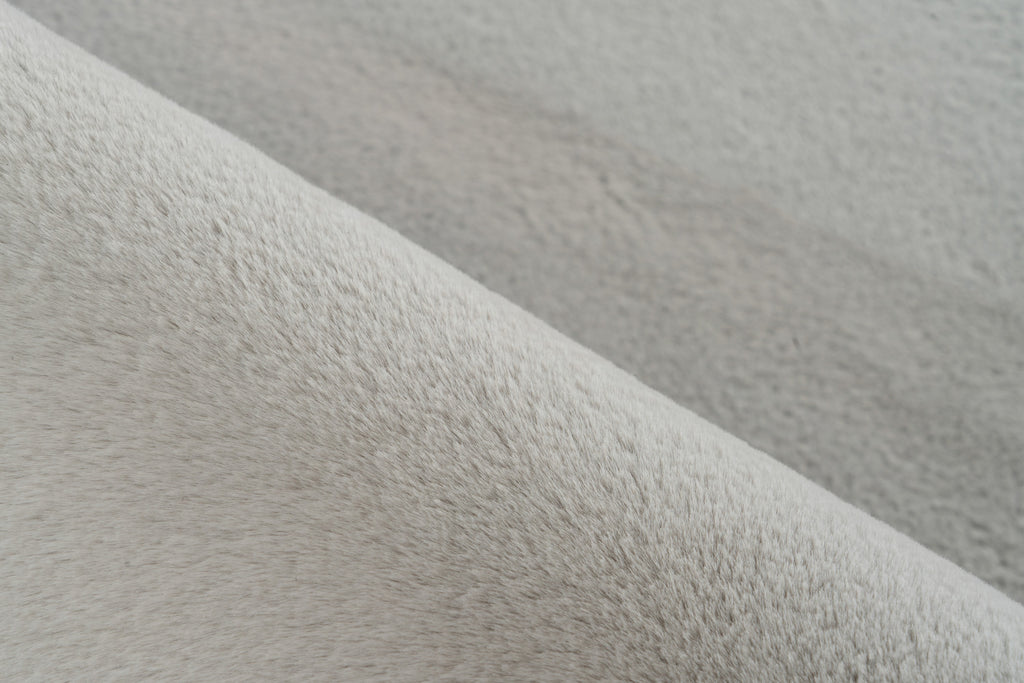 Close-up van vloerkleedmateriaal met zichtbare vezelstructuur