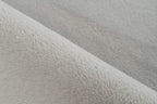 Close-up van vloerkleedmateriaal met zichtbare vezelstructuur