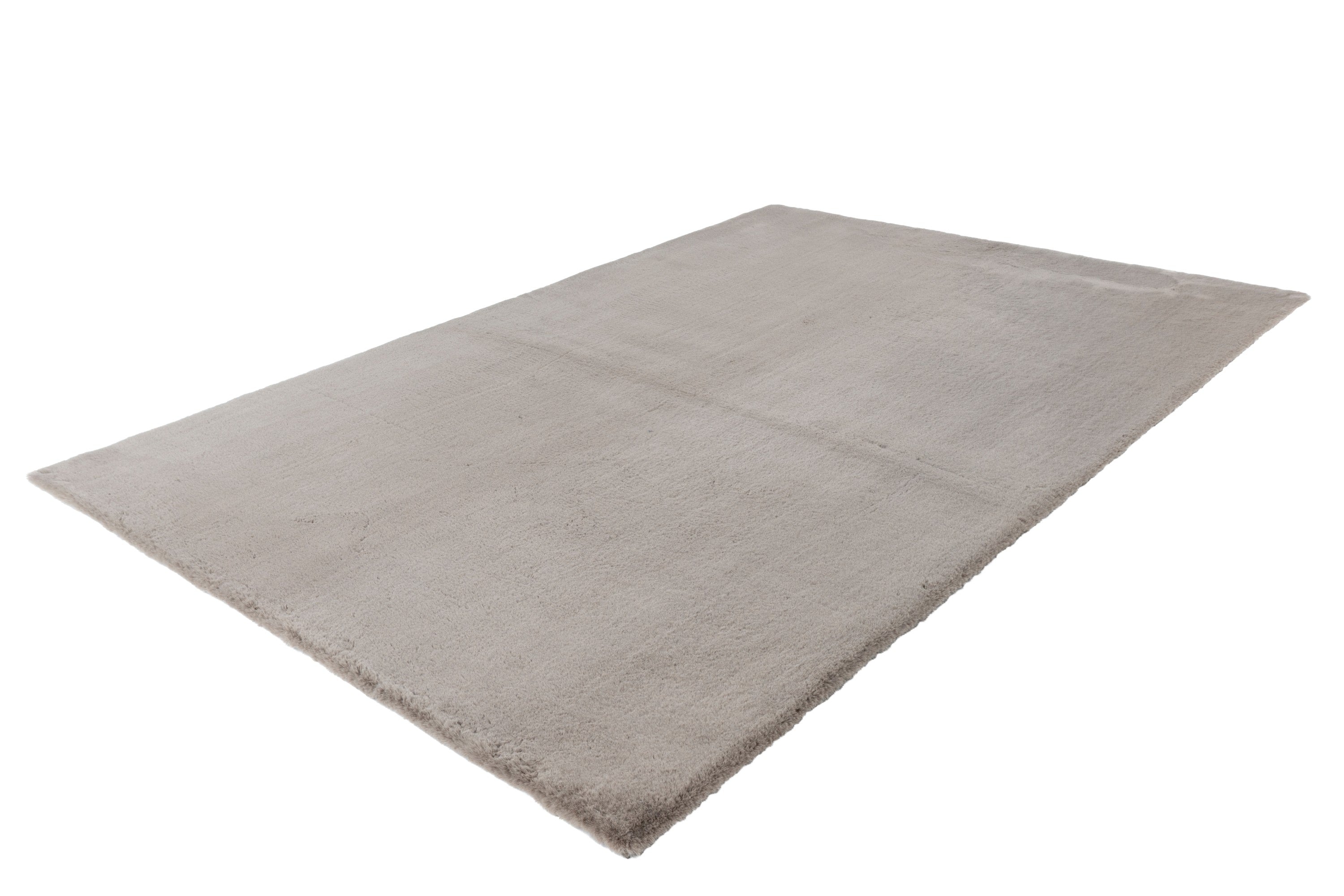 Zijaanzicht van het taupe vloerkleed waarbij de dikte en textuur goed te zien zijn